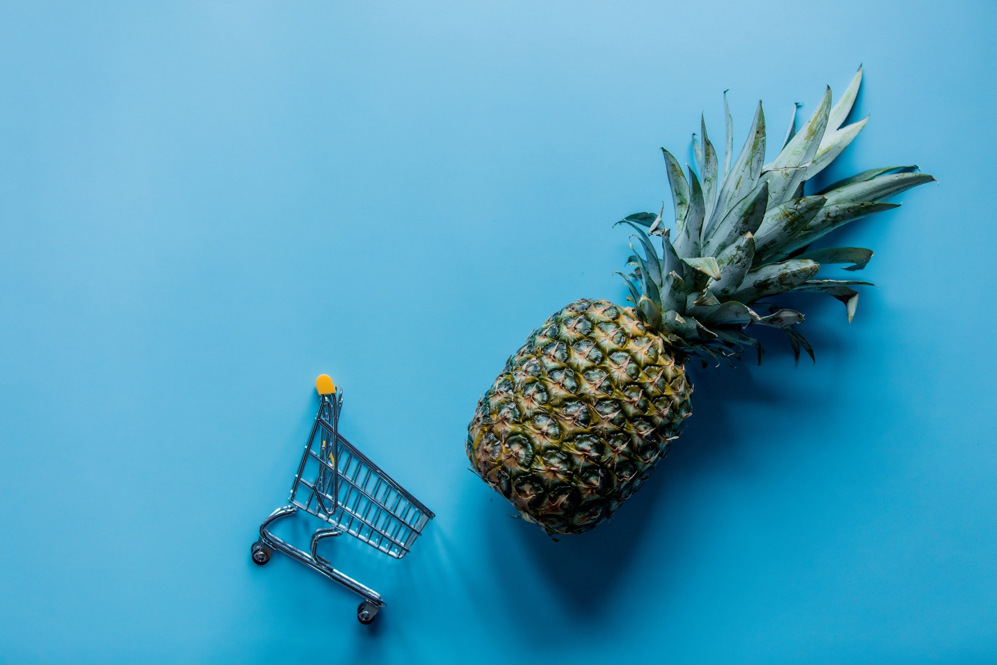 Fresh pineapple with shopping cart